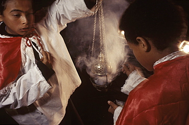 Two young altar boys fill a 200-year-old incensor for a reenactment of the washing of the apostles' feet by Jesus on Holy Thursday in Ouro Preto, a colonial Brazilian city noted for its baroque architecture.