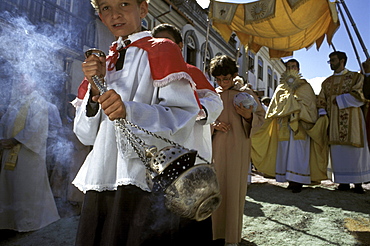 Swinging an incensor, a young altar boy makes way for a local priest carrying the Holy Eucharist during Easter Sunday's procession in Ouro Preto, Brazil.