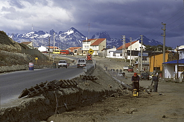 City crews in Ushuaia, Argentina, prepare to pave a dirt track in an fast-growing neighborhood.