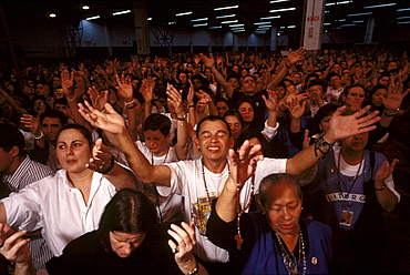 Worshippers at a service by Brazil's charismatic Padre Marcelo Rossi are encouraged to sing, shout and speak in tongues much like their Pentecostal counterparts, yet Catholic traditions, such as communion are preserved. This image is part of a five-part series on the rise of evangelical Protestantism in Latin America.