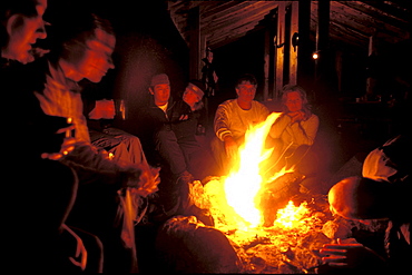 Group members relax around the campfire on the last night of the trip at Pointe a Passe-Pierre camp.