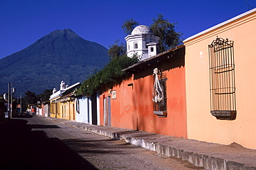 The colonial and colorful streets of Antigua, Guatemala attract tourists for romance and adventure as volcanoes and jungle surround the historic town, named a UNESCO site.