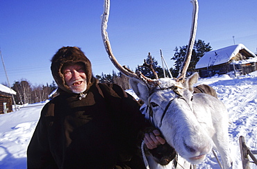 A Khanty reindeer herder with his most prized deer in Houlor. White deer have special significance for the Khanty.