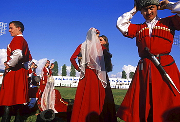 Dancers from a traditional Abkhazian folkdance group adjust their costumes before a performance during a celebration on September 30, 2003 commemorating ten years of "independence" from Georgia, in Sukhum, Abkhazia