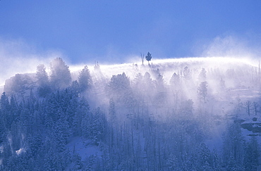 Severe winds blow snow from the mountain and hill tops of Yellowstone National Park.