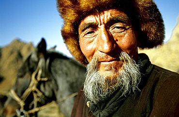 Portrait of a Kazakh Nomad in traditional dressing. Most of the nomads living in the Tavanbogd Atlai National Park are Kazakhs.