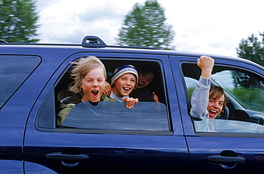 Burton Snowboards Youth team on a roadtrip in Oregon. Kids playing in car.