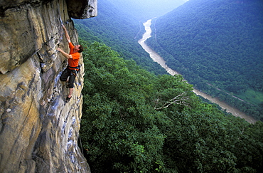 Gene Kissler rock climbing on Discombobulated 5.11a on a sandstone cliff in the New River Gorge, West Virginia.