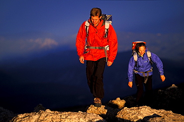 Tommy Caldwell and Beth Rodden hike up hill on a ridge off of Longs Peak in Rocky Mountain National Park, Colorado.