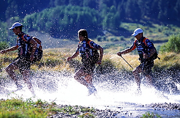 Members of Team Montrail (Novak Thompson, ,Patrick Harper, Rebecca Rusch) train for the next adventure race of the season. The team spends much time hiking, running. In the photo the team crosses a river near Lake Tahoe. Hope Valley, California