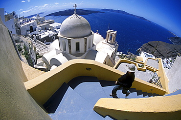 Woman takes leaping strides on the steep staircases of Santorini, Greece.