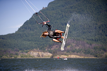 Sky Solbach rips an indie grab while kiteboarding on the Columbia River near Stevenson WA