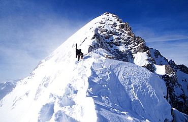 Wade Undem hiking up the East Ridge of Buck Mtn. with his skis in the winter, in Grand Teton National Park, Jackson WY.