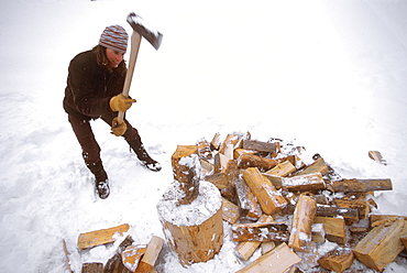 Kit Deslauriers splits logs for firewood in Jackson Hole, Wyoming.