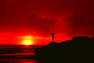 Trey Chace soaks up the last warm light of the day on the Atlantic coast of Costa Rica near Dominical on October 19, 2004. (Photo by Lucas J. Gilman, Aurora)