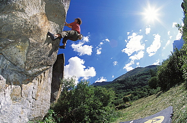 A climber boulders on a sunny afternoon in Tralenta, France.