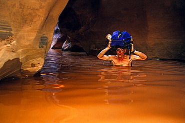 Noel Jones canyoneering in "The Black Hole" of White Canyon, Cedar Mesa, Utah