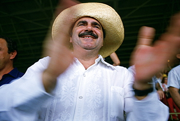 A man claps during a rally for Huber Matos in Miami, Florida. (motion blur)