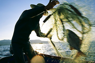 Zen-ei Nakamura, an 88 year old fisherman form the town of Motobu, hauls up his catch from a net he had set earlier.  "Fishing is my life" he said.  "Ikigai" a Japanese word that roughly translated means "reason for living", is something most elderly Okinawans have always had.