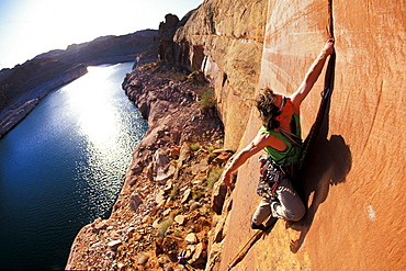 Todd Snyder lead climbing on a first ascent in Lake Powell, Utah