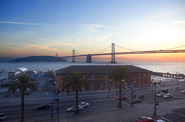 A beautiful sunrise behind the Bay Bridge in San Francisco, California.