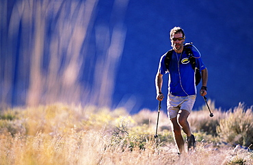 Russ McBride trail running with trekking poles for his endurance training in the Buttermilks outside of Bishop, California.