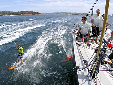 Water skier, Lauryn Eagle  pulled behind the yacht. She was Miss Teen Australia for 2004 and the world speed champion  in speed water skiing for 2005.