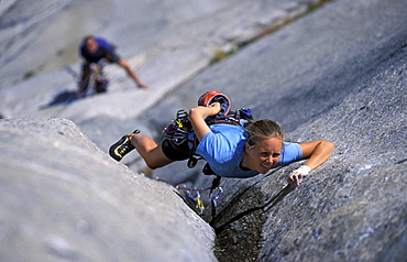 Tommy Caldwell belays female rock climber Beth Rodden as she climbs a crack on the West Buttress climbing route on El Capitan in Yosemite National Park, California. Beth Rodden and Tommy Caldwelll are two of the world's leading big wall climbers.