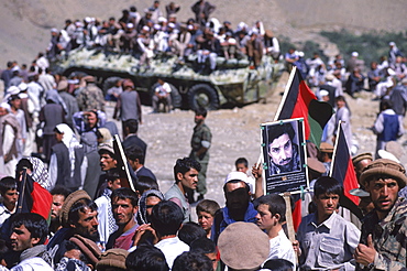 Men, soldiers and schoolboys carry banners and photos to the shrine in the Panjshir Valley of the famous Tajik commander, Ahmad Shah Masood, during a memorial on the one year anniversary of his assasination, September 9, 2002.  Masood was a revered mujahedin leader who also was one of the leaders of the Northern Alliance which opposed the Taliban and helped the US Military in their defeat.  Masood was assasinated by what are thought to be Al Queda operatives on Sept. 9, 2001.  A shrine has been erected in the Panjshir  Valley  from where he led much of his resistance to both the Soviet and Taliban forces, to honor this latest of Afghan war heros.