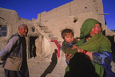 Striking Mongol features distinguish the face of Hamir Mohammed, his daughter and grandson  (who is blind), all living in the ruins of the Qala-i-Dokthar (Daughter's Castle), outside of the town of  Bamiyan, August 30, 2002.  Most of the old town was destroyed and up to 20,000 people of the region might have perished when Bamiyan fell to the Taliban in 2001. Bamiyan Valley is located in the Hazarajat at the edge of the Koh-i-Baba range , the end of the Hindu Kush.  Bamiyan was a prosperous Buddhist kingdom on the ancient Silk Road until the 10th century, when the region  was converted to Islam; in the 12th century, it was destroyed by Ghengis Khan. Most of the people of this region are of the Hazara tribe, and are Shi'a Moslems who have been persecuted for centuries by many of the Pashtun rulers of Afghanistan, who are from the Sunni sect.  They most recently suffered at the hand of the Taliban, who tried for years to ethnically cleanse the region of its Shi'a people