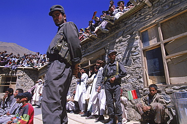 Armed guards keep an eye on the crowds during a ceremony below the shrine of Ahmad Shah Masood in the Panjshir Valley, September 9, 2002. Masood was a revered mujahedin leader who fought the Soviets in the Afghan-Soviet war, and who also was one of the main leaders of the Northern Alliance which opposed the Taliban and helped the US Military in their defeat.  Masood was assasinated by what are thought to be Al Queda operatives on Sept. 9, 2001.  A shrine has been erected in the Panjshir  Valley, near the village of Bazarak, from where he led much of his resistance to both the Soviet and Taliban forces, to honor this latest of Afghan war heros.