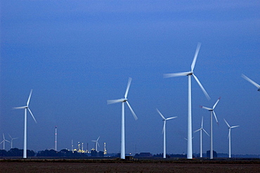 A wind power installation towers over the Shell-DEA oil refinery plant near the town of Heide in the German state of Schleswig-Holstein.  Situated between Germany's two coastlines, the northern state has invested heavily in new, renewable energies.  In 2005, there were 2.595 wind turbines in Schleswig-Holstein, generating over 30% of the state's energy.  Wind power accounts for 6,7% of Germany's overall energy needs.