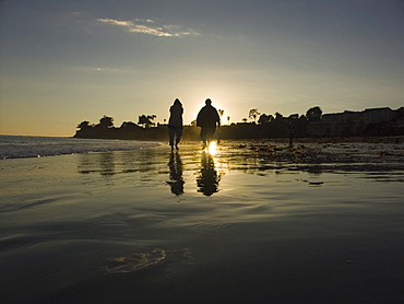 Tourists, visitors enjoy the beaches and palm trees in Santa Barbara, California at susnet.