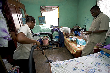 Research assistants and technicians from the University of Ghana collect dust samples from the living rooms and bedrooms of  children in Accra, Ghana.  The samples will be analyzed for the presence of dust mites, fungus', and animal allergens to help researchers better understand why children in wealthier homes have higher rates of allergies and asthma than poorer children.  The leading theory is that higher rates of helminth (parasite) infections among poorer children are affecting the immune system in a way that offers protection from allergies and asthma.  The study aims to find out what the worms are doing, isolate the beneficial effect and replicate it.