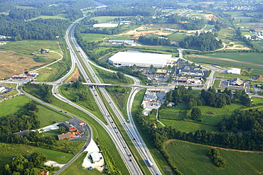 Aerial view of commercial growth clustered around an interstate exit near Hendersonville, NC.