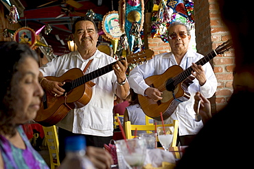 Two mariachis performing for customers at a restaurant in San Antonio, Texas.