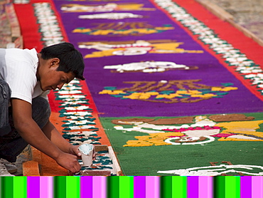 As part of the observance of Lent in Guatemala, a person prepares an aromatic carpet for a procession in Antigua, Guatemala