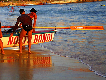 A group of people preparing a surf boat in Sydney, Australia.