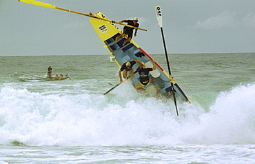 A group of people on a surf boat during a surf carnival in Sydney, Australia.