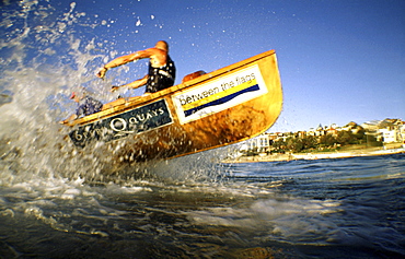 A group of people on a surf boat during a surf carnival in Sydney, Australia.