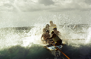 A group of people on a surf boat during a surf carnival in Sydney, Australia.