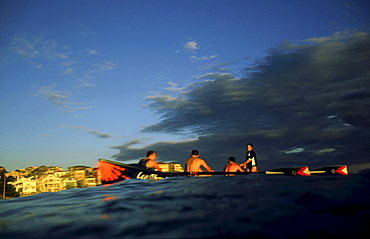 A group of people on a surf boat during a surf carnival in Sydney, Australia.