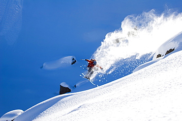 Man skiing powder, jumping, Wyoming