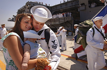 Sailor hugs his wife and baby