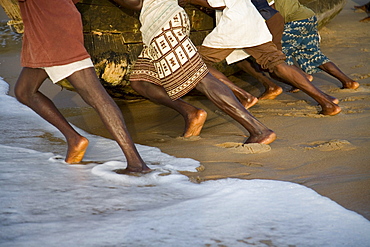 Closup of legs pushing a boat