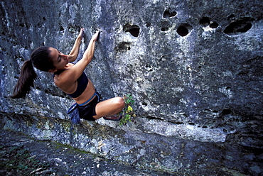 Woman bouldering near Austin, Texas.