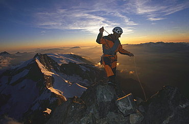 Mountain guide on the top of a peak.