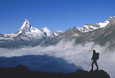 During the road around of Matterhorn, a trekker and in background the nort face of Matterhorn, just above Zermatt