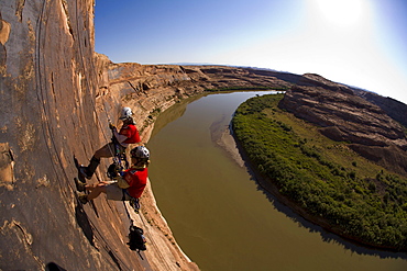 Adventure racers rappelling over a river in a race in Moab, Utah.