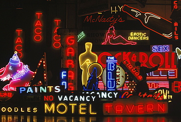 Scott Young moving a sign at 'Nights of Neon'- a neon production company that manufactures and rents neon signs to the film industry.